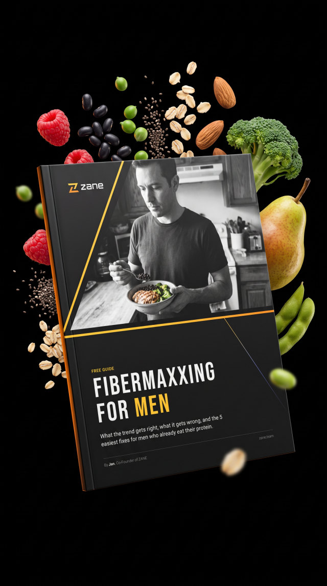 The guide Fibermaxxing for Men surrounded by beans, berries, broccoli, oats and almonds